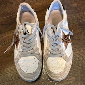 Distressed white golden goose sneakers with an animal print star
